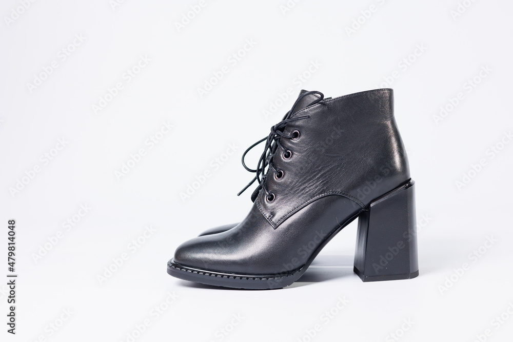 Women's boots with black genuine leather on heels isolated on a white background. photo from the side, diagonally and foreshortened from behind. Women's shoe collection 2022 Women's boots with black genuine leather on heels isolated on a white background. photo from the side, diagonally and foreshortened from behind. Women's shoe collection 2022