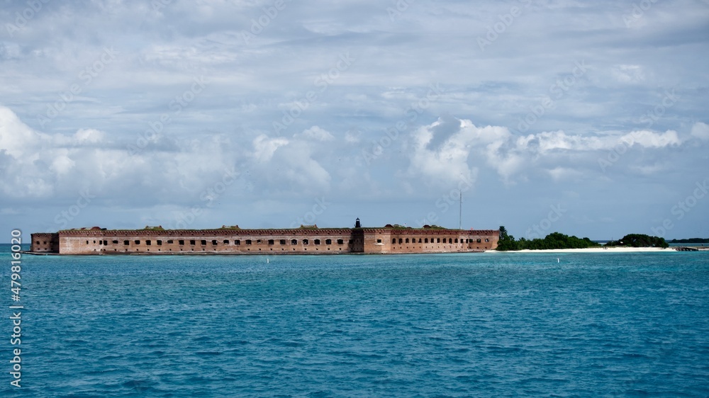 Fort Jefferson, Dry Tortugas National Park, Garden Key, Florida Keys. Fort as seen from the water. A massive, unfinished coastal fortress, largest brick masonry structure in the Americas. Fort Jefferson, Dry Tortugas National Park, Garden Key, Florida Keys. Fort as seen from the water. A massive, unfinished coastal fortress, largest brick masonry structure in the Americas.