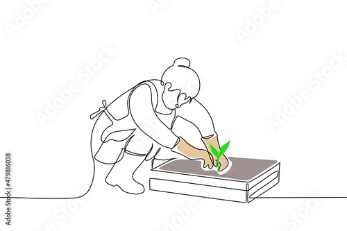 woman  in apron sits in front of box with earth, on rubber boots and on gloves, gardener holding young seedling - one line drawing vector. vegetable garden concept, replant seedlings