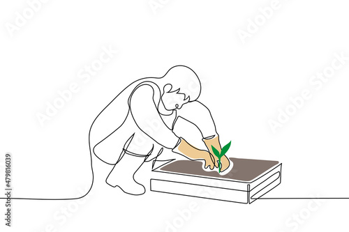 man squatting in front of box of earth and digging green seedling - one line drawing vector. home garden concept, transplant seedlings, plant plant