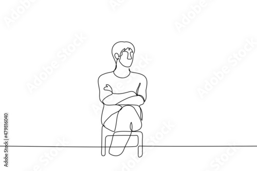 man sits with his legs and arms crossed and looks somewhere - one line drawing vector. closed pose concept, non-contact person, waiting, viewer or listener