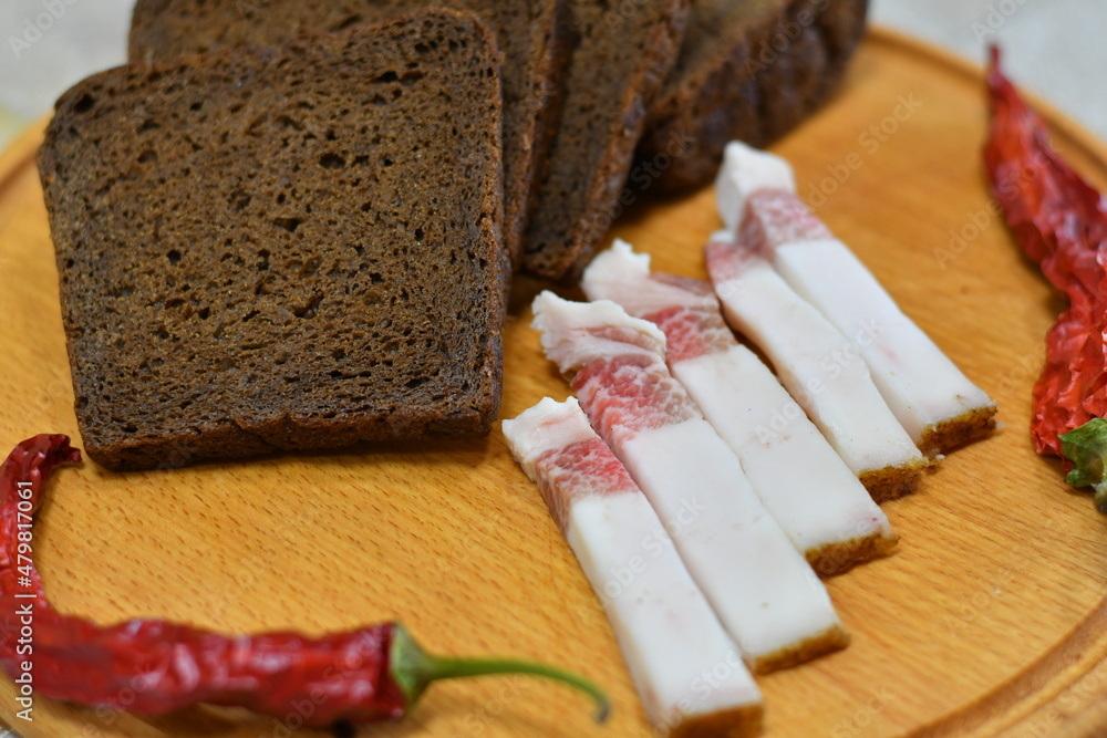 slices of bacon. white lard. Chunks of salted bacon on dark background