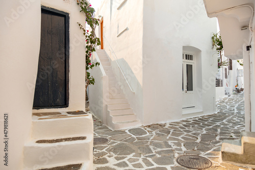 Paros island, Greece. Whitewashed building, empty narrow cobblestone street at Naousa old town