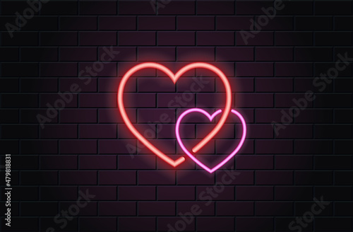 Red and pink neon heart for valentines day on black brickwall background