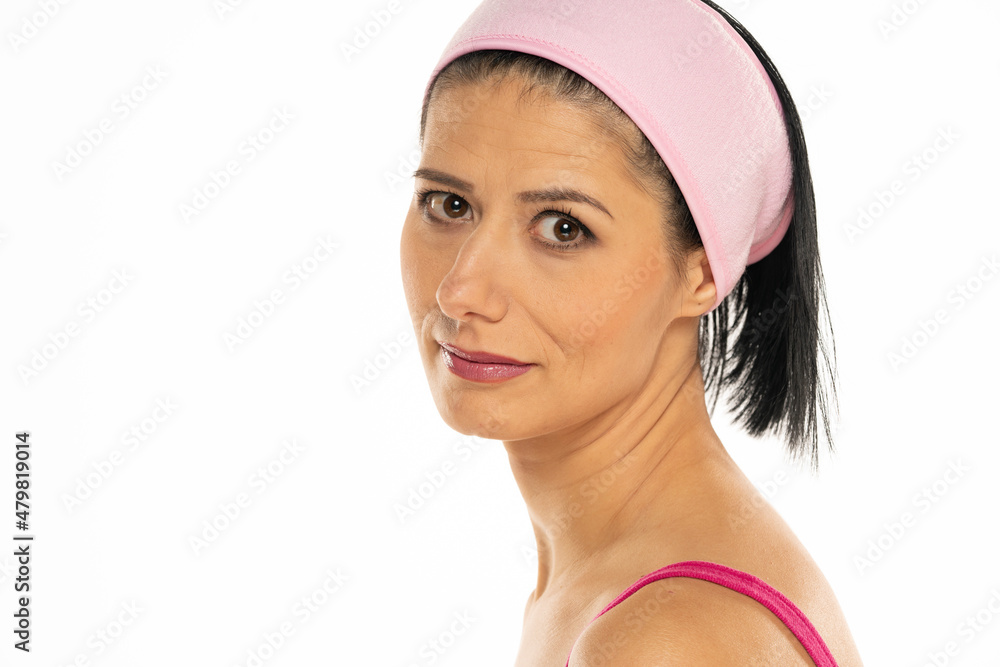 Headshot of middle-aged smiling woman with makeup and headband Headshot of middle-aged smiling woman with makeup and headband