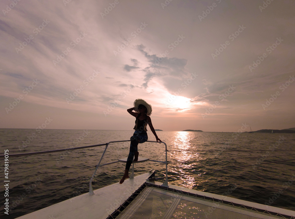 Silhouette of a girl on a yacht at sunset, Andaman Sea, Thailand