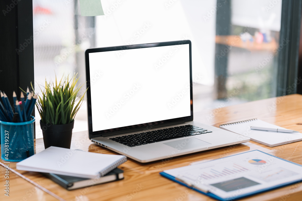 Laptop computer with blank white screen on table. Laptop computer with blank white screen on table.