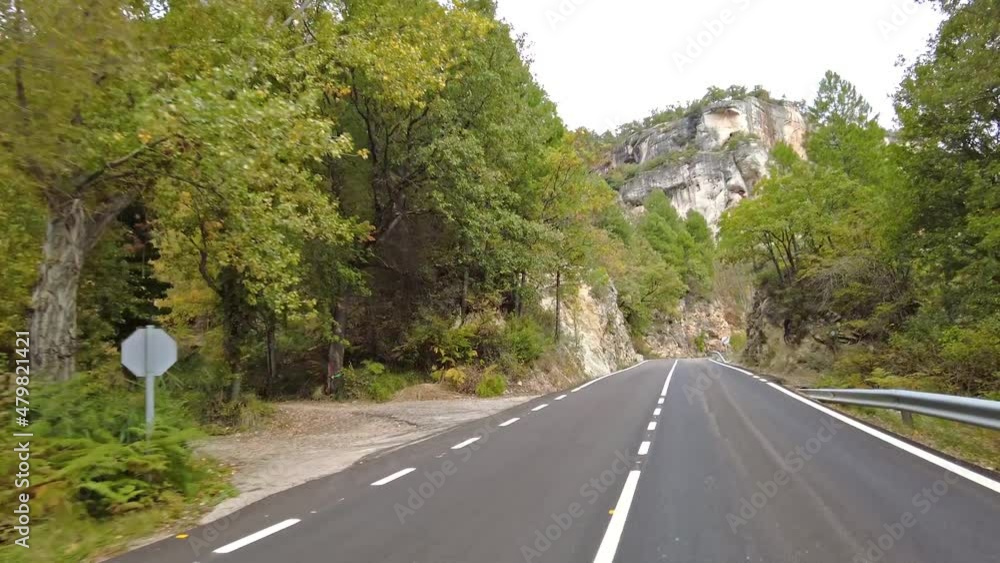 Driving along the karstic cliffs in large lagoon of Tobar at Hoz de Beteta, Cuenca, Castilla la Mancha, Spain, Landscapes of the mountain range of Cuenca Driving along the karstic cliffs in large lagoon of Tobar at Hoz de Beteta, Cuenca, Castilla la Mancha, Spain, Landscapes of the mountain range of Cuenca