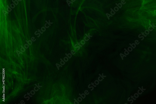 Green steam on a black background. © Nikolay