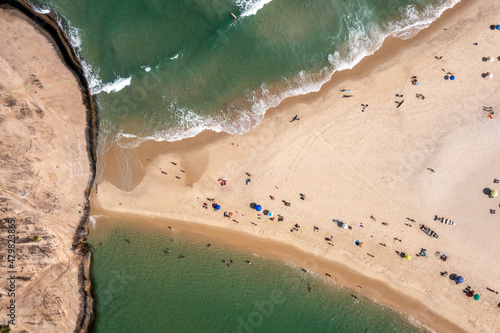 Linda vista aérea da praia da Macumba, no Recreio dos Bandeirantes, Rio de Janeiro, mostrando a estreita faixa de areia que liga à montanha e divide a praia do Recreio da praia da Macumba. photo