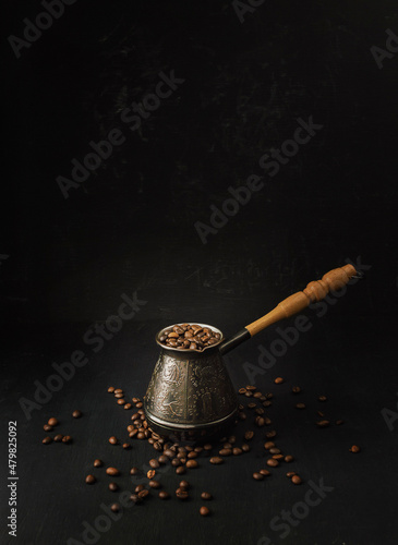 coffee concept. Coffee beans in Cezve. on the table, hot and fresh morning coffee. Brown roasted coffee. copyspace. photo
