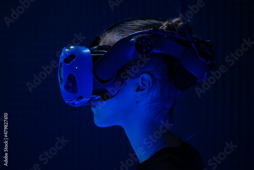 A teenage girl in glasses for virtual reality. Technology. Computer games. Progress.