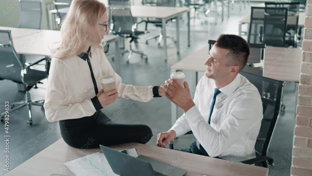 friendship and support in the office businessman and woman have coffee break talking and laughing friendship and support in the office businessman and woman have coffee break talking and laughing