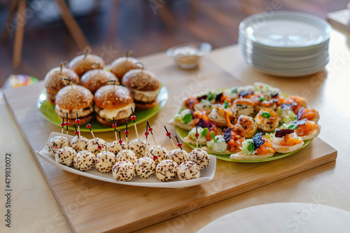 Canapes with cheese balls topped with sesame seeds. Cheese appetizer for the festive table.