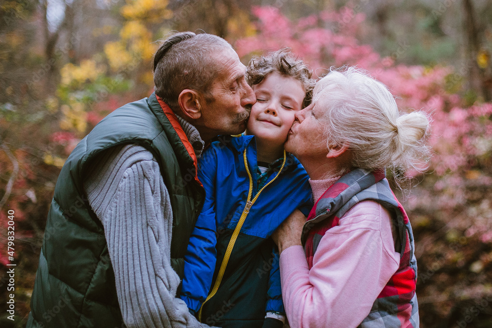 Grandparents kissing a grandchild Grandparents kissing a grandchild