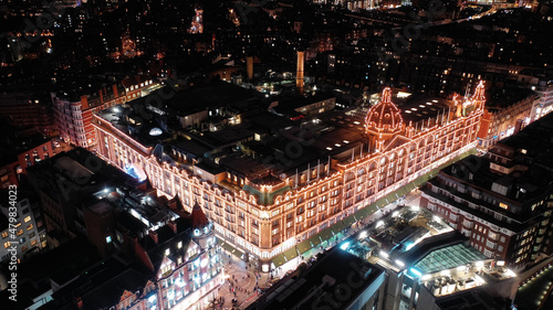 Aerial drone night shot of iconic illuminated Harrods department store at Knightsbridge at Christmas time, London, United Kingdom © aerial-drone