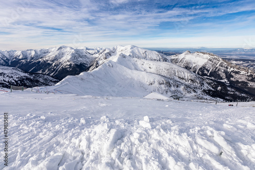 Tatra mountians at winter time. View of the white snow-capped peaks, frosty winter mountains. Kasprowy Wierch, High Tatra, Poland, Europe. © Curioso.Photography