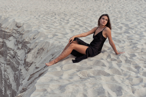 Tanned brunette in the sand dunes