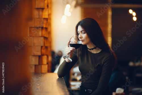 Beautiful girl holding a glass of vine