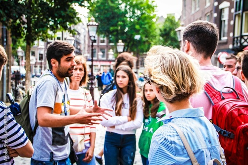 Tour Guide during a explanation in Amsterdam with a group of tourist.