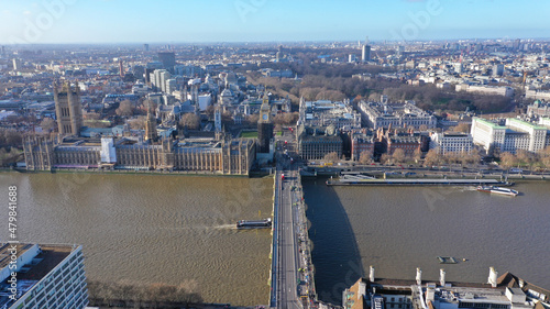Aerial drone photo of iconic City of Westminster with houses of Parliament, Big Ben and Westminster Abbey in front of river Thames, London, United Kingdom