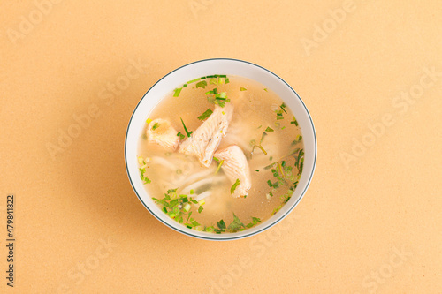 Banh canh ca loc, Thick Rice Noodles with Snakehead Fish, ietnamese food isolated on beige background, top view photo