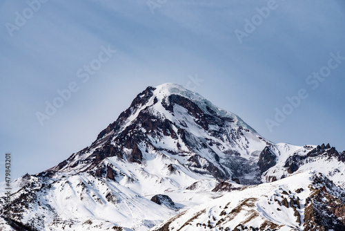Fototapeta Naklejka Na Ścianę i Meble -  High snow covered mountain Kazbek. Winter mountains landscape. Georgia,  Kazbegi.