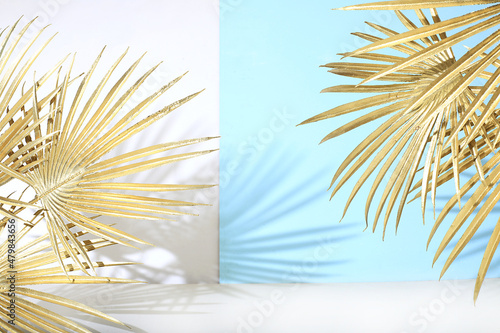 Empty showcase for showcase or presentation of cosmetic products, stage for design, Abstract background with golden palm leaves and shadows, modern creative display, selective focus