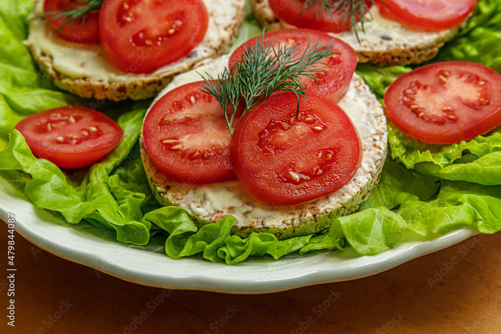dietetic crispbreads with cream cheese and tomato slices on lettuce leaves on a plate, healthy lifestyle concept dietetic crispbreads with cream cheese and tomato slices on lettuce leaves on a plate, healthy lifestyle concept