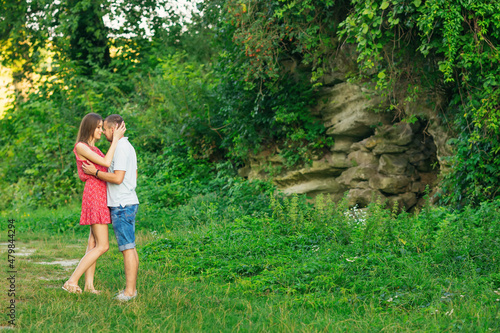 Fototapeta Naklejka Na Ścianę i Meble -  Beautiful couple in love hugging, against the backdrop of rocks,