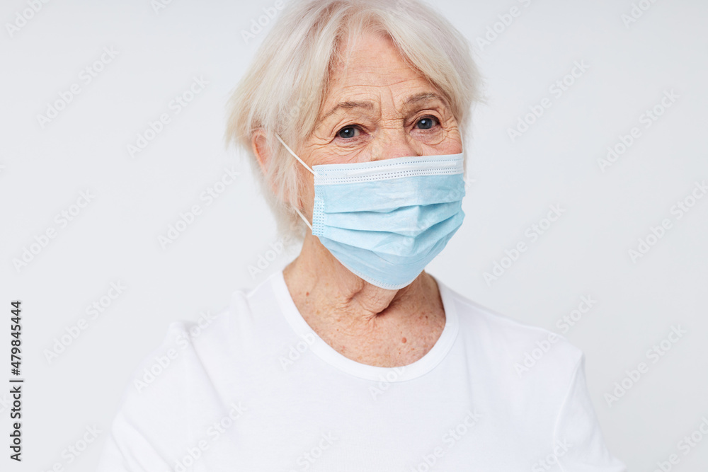 Photo of retired old lady respiratory protection isolated background Photo of retired old lady respiratory protection isolated background