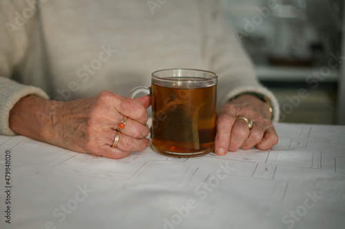 Senior woman holding a glass of tea