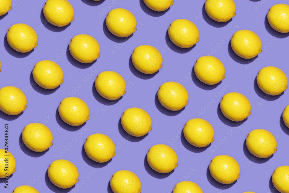 Fruit lemon in checkered pattern on violet background. Violet and yellow colors background from fruity lemon. Demonstrating very peri, color of 2022 year.