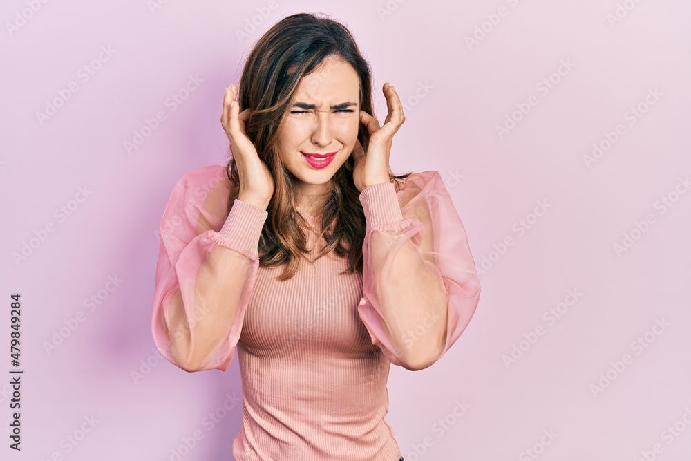 Young hispanic girl wearing casual clothes covering ears with fingers with annoyed expression for the noise of loud music. deaf concept. Young hispanic girl wearing casual clothes covering ears with fingers with annoyed expression for the noise of loud music. deaf concept.