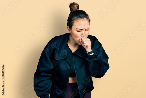 Young hispanic girl wearing sportswear feeling unwell and coughing as symptom for cold or bronchitis. health care concept. © Krakenimages.com