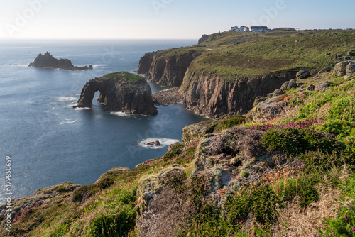 Land's End at sunset with Enys Dodman arch, Cornwall