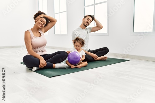 Couple and daughter smiling confident stretching at sport center