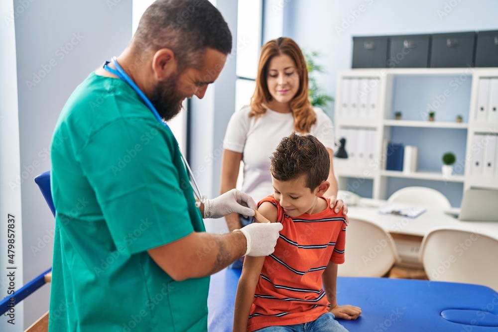 Fototapeta premium Family vaccinating child having medical consultation at clinic