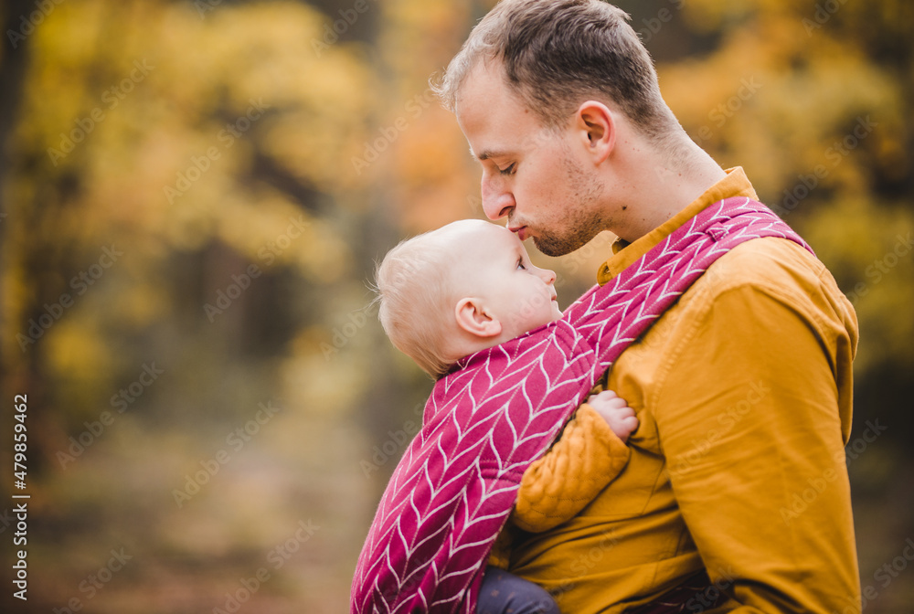 Father and a baby in a baby carrer picture Father and a baby in a baby carrer picture