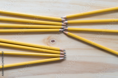 several sharpened wood pencils on a wooden surface