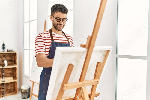 Young arab artist man smiling happy drawing at art studio.