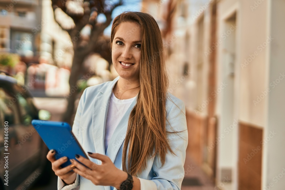 Young blonde businesswoman working using touchpad at the city. Young blonde businesswoman working using touchpad at the city.