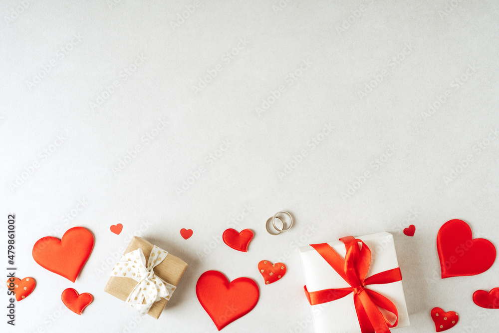 Background with gift and hearts with free space for text on concrete grey background. Valentines day concept. Mother's Day concept. Greetings card. Copy space. Flat lay, top view.