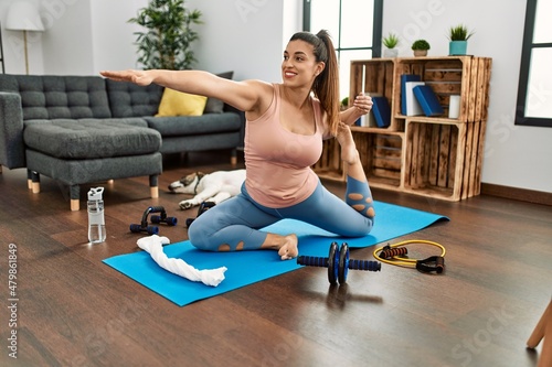 Young woman smiling confident training yoga at home