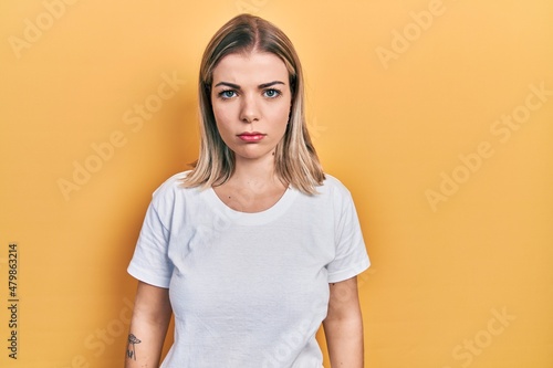 Beautiful caucasian woman wearing casual white t shirt skeptic and nervous, frowning upset because of problem. negative person.