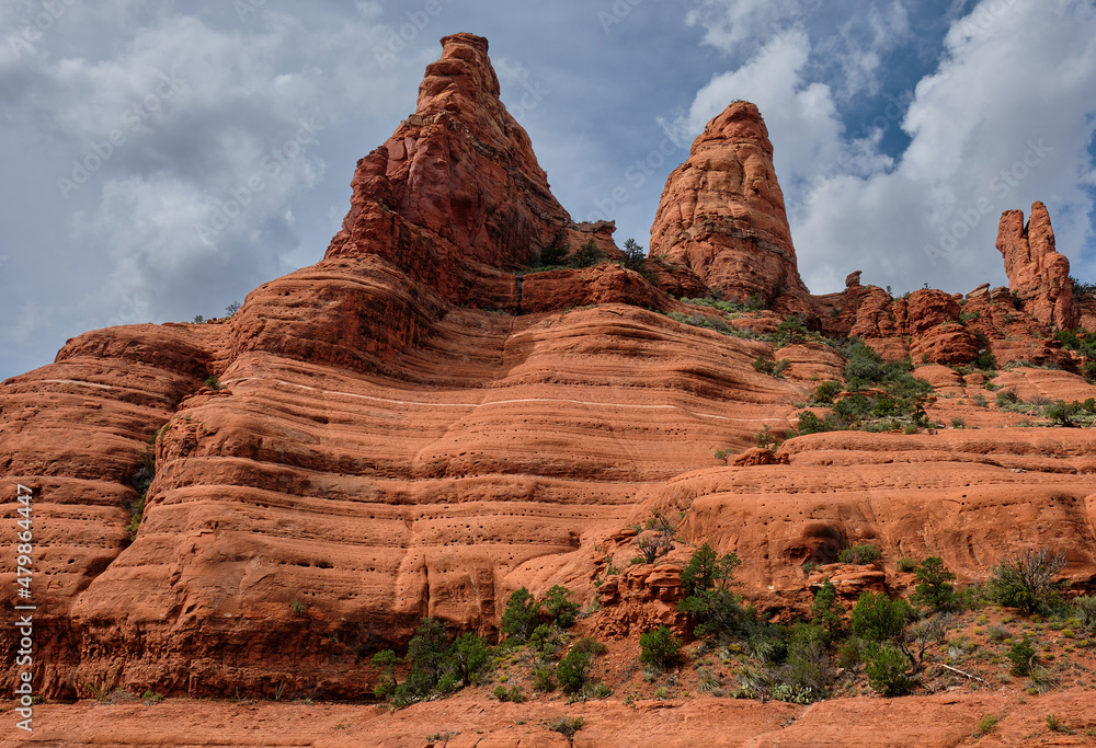 Streaker Spire (left), Christianity Spire and the White Line, Sedona, Arizona. The White Line, halfway up the rock face, is a popular challenge for mountain bikers.