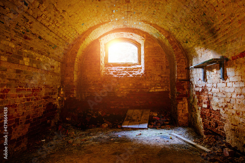 Vaulted red brick dungeon under old mansion
