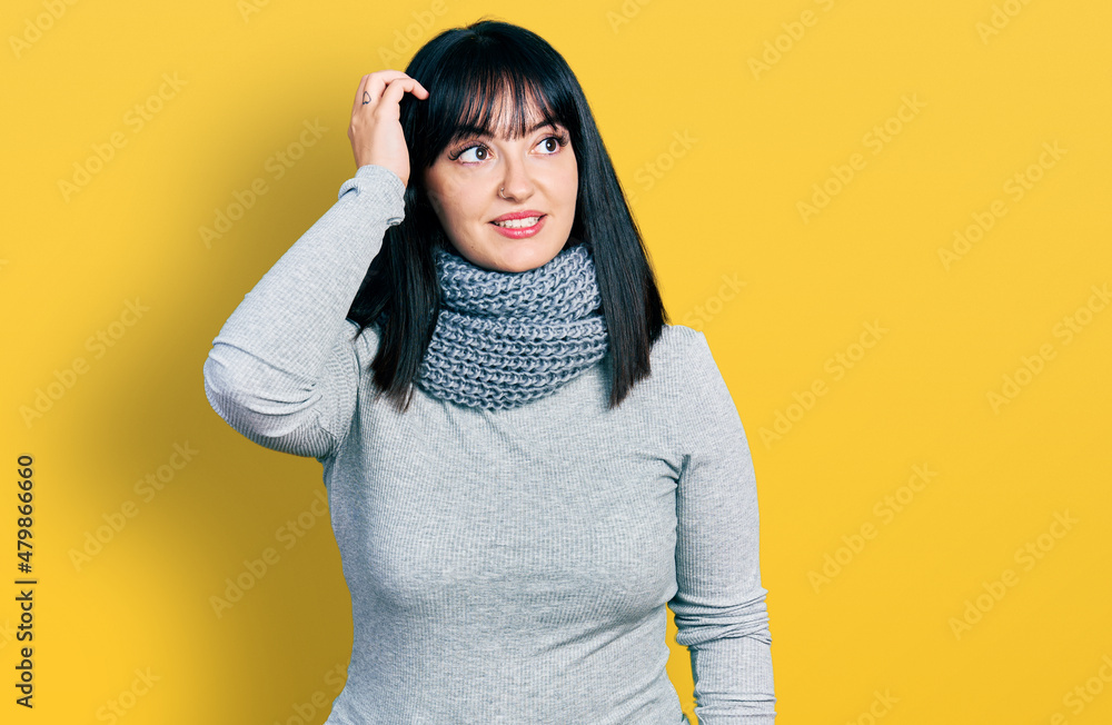 Young hispanic plus size woman wearing winter scarf smiling confident touching hair with hand up gesture, posing attractive and fashionable Young hispanic plus size woman wearing winter scarf smiling confident touching hair with hand up gesture, posing attractive and fashionable