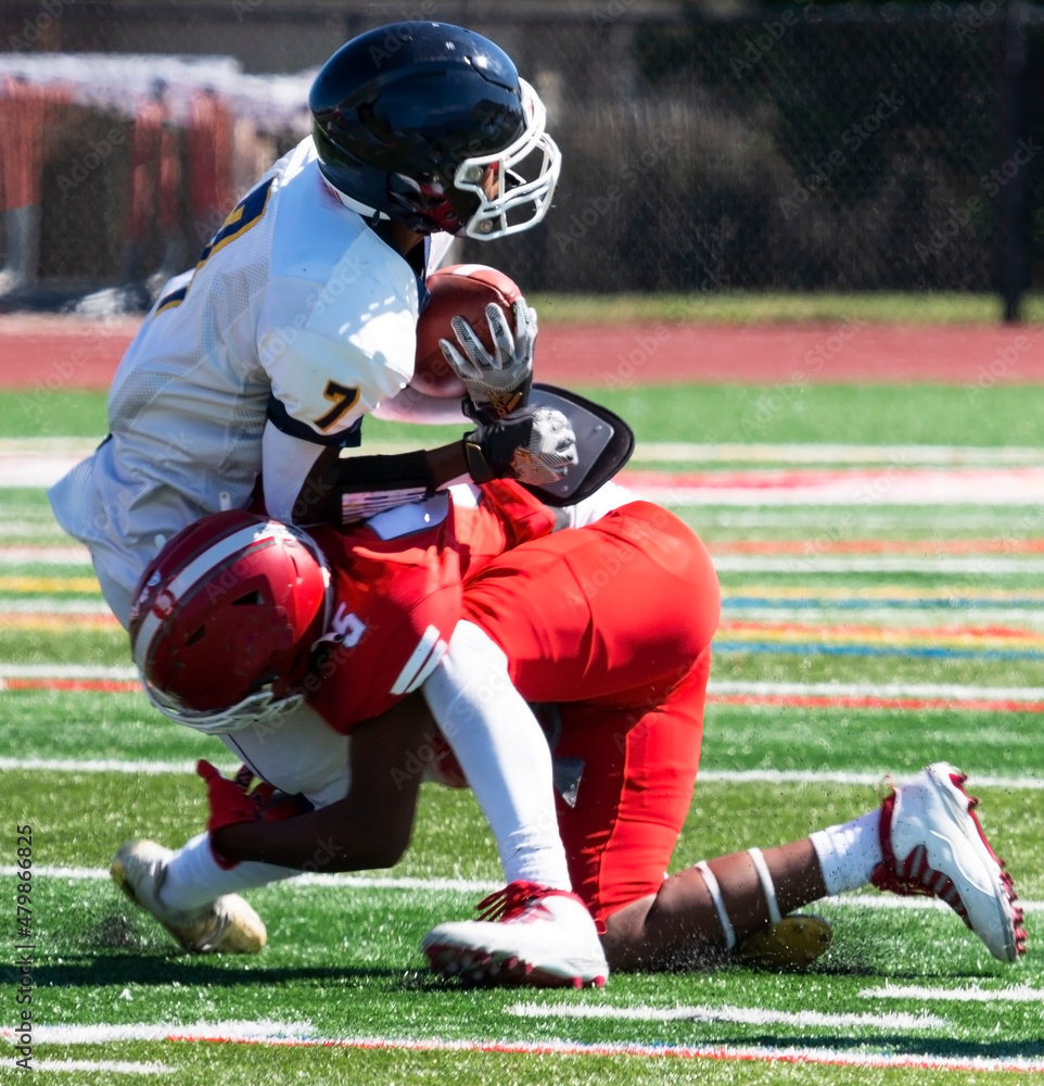 One on one tackle during a football game close up One on one tackle during a football game close up