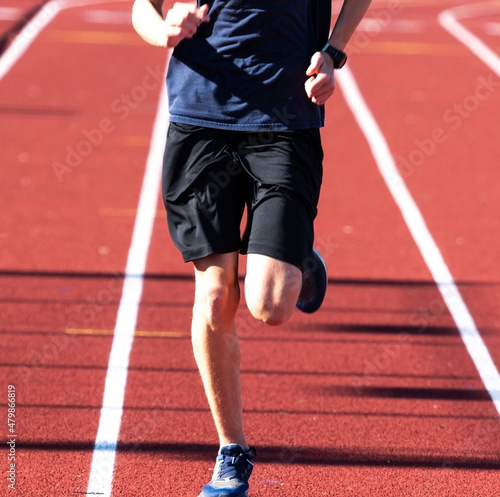 One runner running on a red track